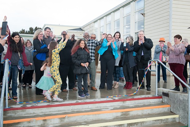 Everyone's all smiles after Salem Smith, who was in the Seed program at the center from the beginning, cut the ribbon celebrating the completion of phase one of the Jefferson Community Center and Park. - MARK MCKENNA