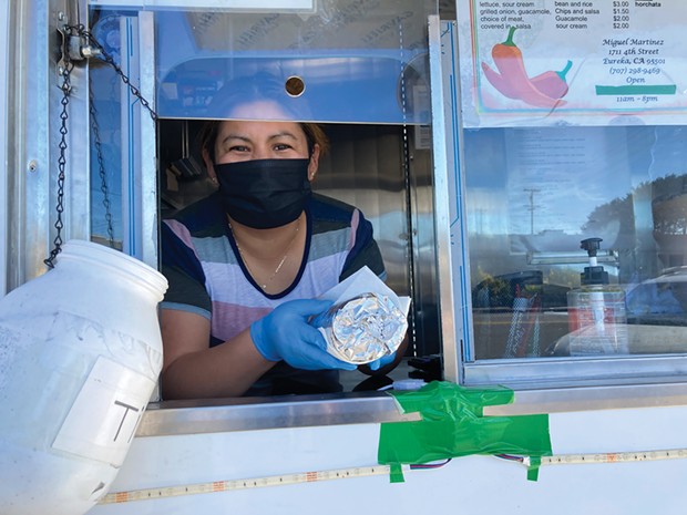 Francisca Vereugo serves up a burrito from the Taqueria Martinez truck.