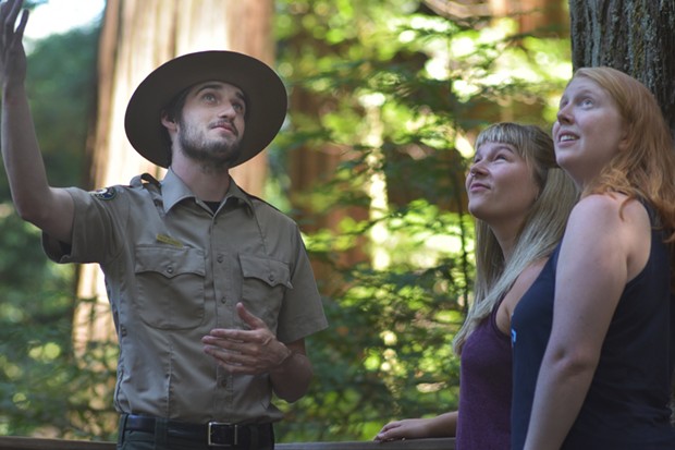 State Park Interpreter leads visitors on a guided hike in the redwood forest.