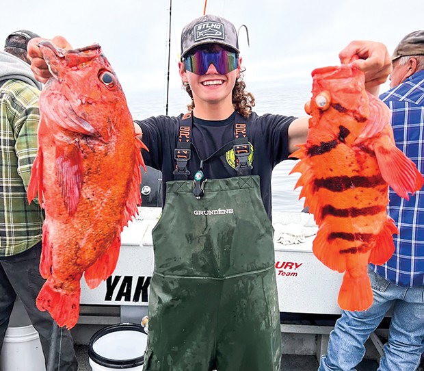 Brookings Fishing Charters deckhand Eric Howard holds a vermilion and tiger rockfish caught July 30 at the Point St. George Reef Lighthouse near Crescent City.