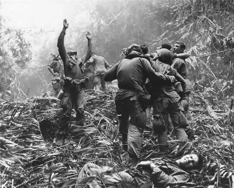 Eric Hollenbeck is just out of frame in this iconic photograph. His long-held belief that the man lifting his arms in the air is the Sergeant he shadowed throughout the war was finally confirmed in 2014. / Courtesy of Art Greenspon.