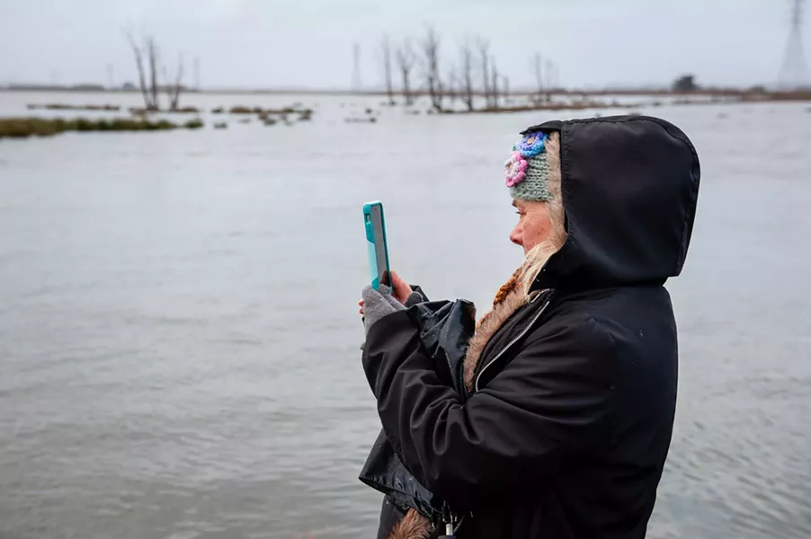 Sherry Van Fossen photographs the King Tide at the Arcata Marsh. - MARK MCKENNA