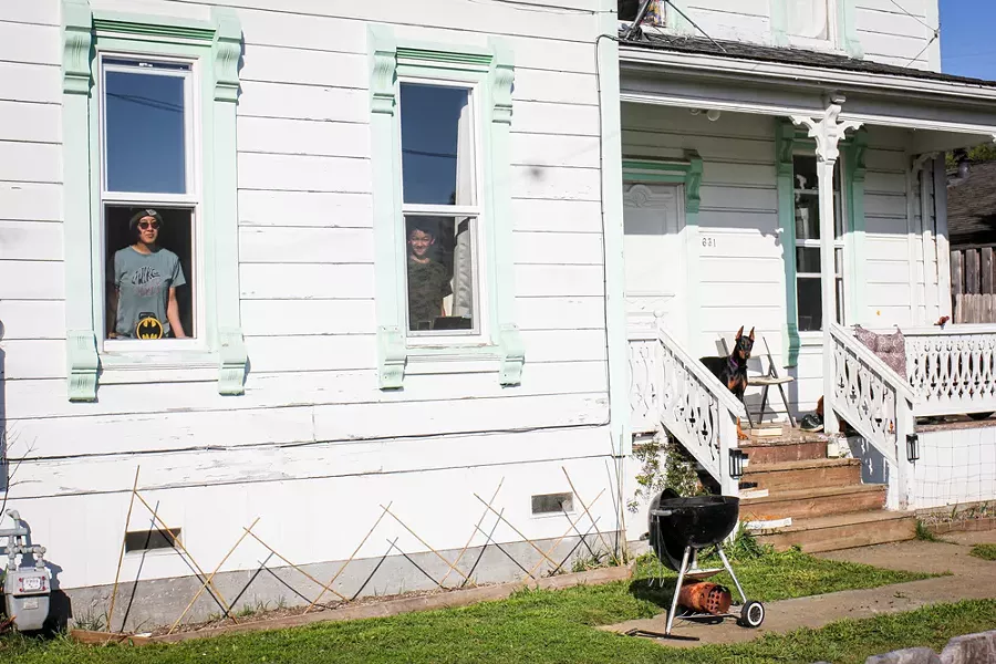 "I saw this house from across the street where I was taking another portrait and asked about it. They said it was a rental and people had just moved in. The house intrigued me — it has character. Ezekiel and his mother, J, came onto their porch to read a book and I met them from far back on the street. I can't imagine just moving into a new place and then having to stay in. There is so much unknown surrounding the unknown in that." - JANESSA JOHNSRUDE'S