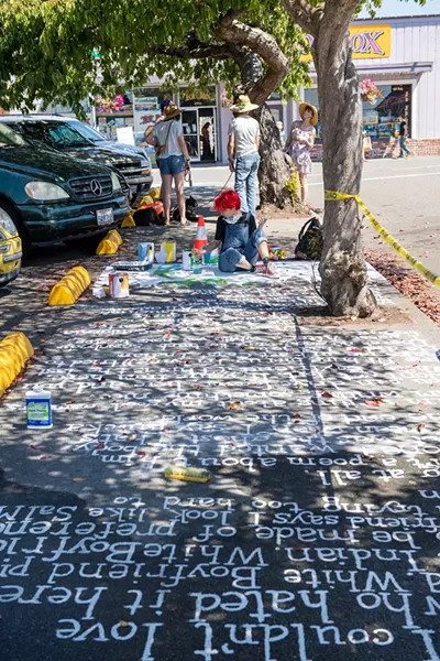 This year's festival included poetry painted on the sidewalks, such as this piece written and painted by Harvey Mitchell. - PHOTO BY MARK MCKENNA