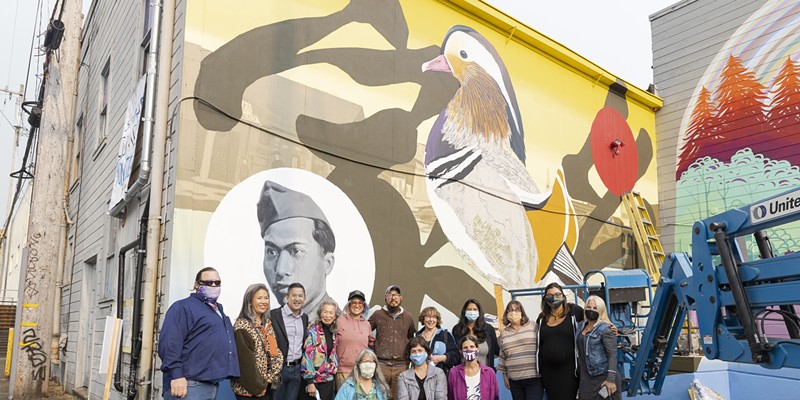 Representatives from mural sponsors Papa & Barkley, as well as the city of Eureka, join artists Dave Kim and Cate Be posing with Mary Chin, widow of Ben, and their youngest son Don, with ECP members Alex Ozaki-McNeill, Patty Hecht and Brianne Mirjah D’Souza, and Jean Pfaelzer in front of the completed mural “Fowl.”