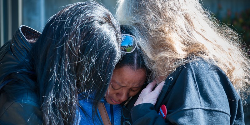 Charmaine Lawson is hugged by supporters at a 2019 vigil for her son, David Josiah Lawson.
