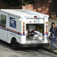A mail carrier wearing a mask and gloves in Berkeley on March 27, 2020. Postal employees are considered essential during the shelter in place.