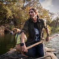 Josh Lowe, 32, made a makeshift raft out of longboards and wood to get across the San Mateo Creek to where he has been staying in San Clemente on Nov. 6, 2021. Lowe moved to the woods with his dog Anna since the encampment on the CalTrans property was disbanded on August 27th.