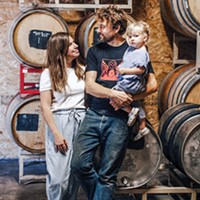 Carla Barroso, Miles Garrett and 3-year-old Gala with barrels of natural wine.