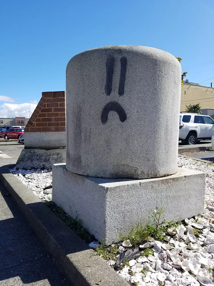Frowny graffiti on Fourth Street in Eureka. - PHOTO BY GABRIELLE GOPINATH.