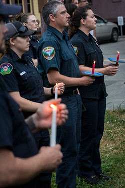 PHOTO BY MARK LARSON - Members of the fire departments of Fortuna, Rio Dell and Ferndale joined in the candlelight vigil  to show support for the Dallas victims in Fortuna on July 8.