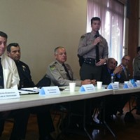 Undersheriff Bill Honsal (standing) responds to a community member's question at Wednesday's meeting.