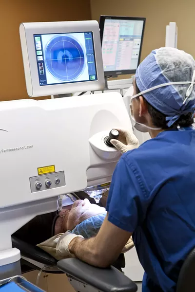 Viewing the patient's eye on a high-definition video monitor, ophthalmic surgeon Paul Imperia adjusts the position of the Intralase that will create the corneal flap. - PHOTO BY BRIAN PRECHTEL