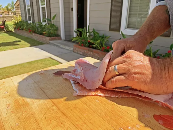 FILET-O-FISH There are several tricks to filleting fresh caught fish, but the most common involves slicing along the spine and above the ribs from collar to tail. - PHOTO BY CAMILLIA LANHAM