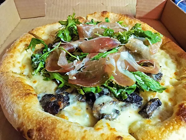 PIZZA TO-GO Local favorite, the Forager, comes with roasted mushrooms and a creamy white sauce. - PHOTOS BY BETH GIUFFRE