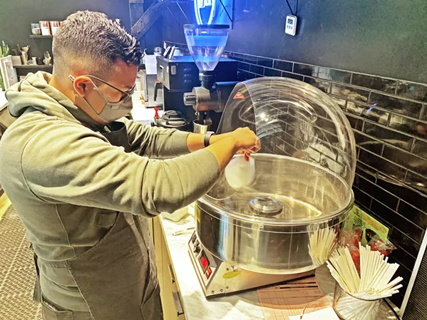 SUGAR RIDE Active Coffee Co. barista Pablo Arriola spins flavored sugar into a cloud pop ready to top a chai latte. - PHOTO BY CAMILLIA LANHAM