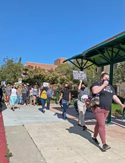 CONTINUED SUPPORT About 40 people gathered in front of the Palm street entrance of the SLO County Courthouse in protest of the SLO County District Attorney’s Office’s recent motion to file a gag order against Tianna Arata and four other protesters. - PHOTO BY KAREN GARCIA