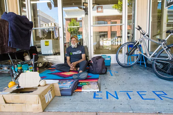DOWNTOWN HOME Jeb, homeless for five months, hangs out in front the former Beverley's Fabrics building in downtown SLO. - PHOTO BY JAYSON MELLOM