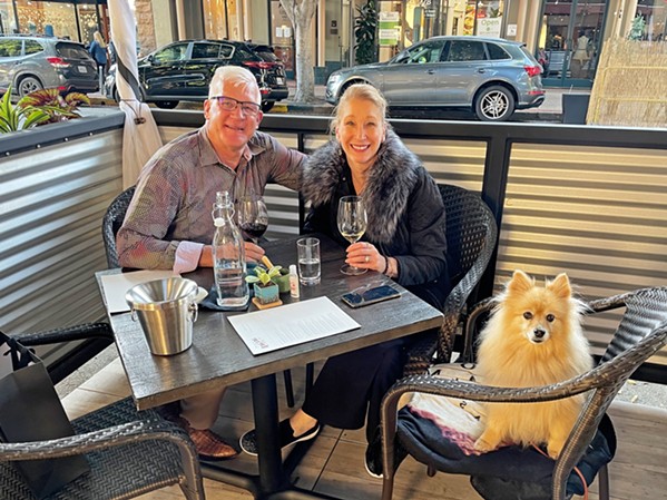 TABLE FOR THREE customers Jeff and Pam Forrest and their 13 year old Pomeranian Rambeau enjoy the terrace area in front of the tasting room.  - PHOTO BY CHERISH WHYTE