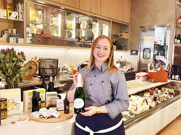 SAY CHEESE Sommelier Jenna Isaacs can help guests assemble luxury gift baskets featuring a cornucopia of house-made, local, and imported items, including dozens of cheeses and more than 2,000 wines from around the world. - PHOTO BY CHERISH WHYTE