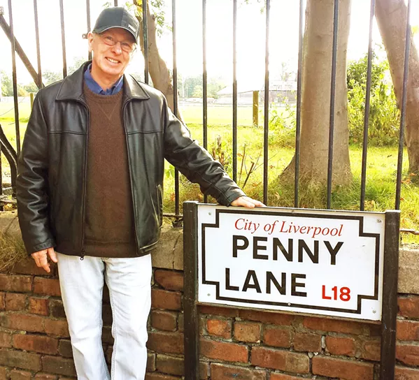 PILGRIMAGE Shown here at Penny Lane, Beatles expert Mark Brickley, author of Postcards from Liverpool: Beatles Moments & Memories , will present via Zoom his multimedia presentation The Beatles Road to Stardom: 1956-1964, on Sept. 8, through the SLO County Public Library. - PHOTO COURTESY OF MARK BRICKLEY