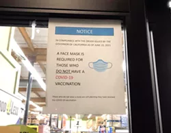MASK OPTIONAL According to Atascadero resident Colleen Annes, this sign was posted at the city’s Food4Less location as recently as Oct. 8. As of Oct. 12, it appeared the grocery store’s signage was requiring masks for all, though many customers inside were not wearing them. - PHOTO COURTESY OF COLLEEN ANNES