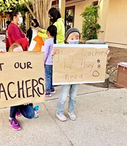 YOUNG SUPPORTER A Glen Speck Elementary student holds up a homemade sign at the Rally for Paso Robles Teachers, held Oct. 12. - PHOTO BY MALEA MARTIN