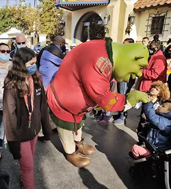 SHREK TREK A 7-foot-tall Shrek (dressed in a cute Christmas sweater) greets guests young and old at Universal Studios Hollywood. - PHOTOS BY CALEB WISEBLOOD