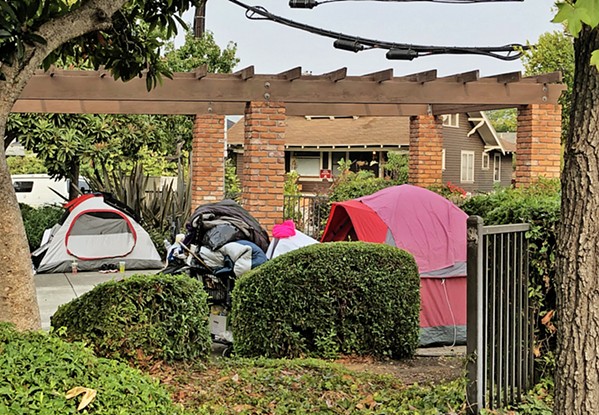 TENT BAN Earlier this year, the city of SLO put up signage declaring a ban on homeless encampments in public spaces like the tents seen at Mitchell Park. - FILE PHOTO COURTESY OF THE CITY OF SLO