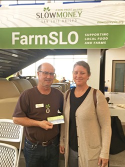 HELPING HAND Slow Money SLO Founder Jeff Wade presents a sponsorship opportunity to a farmer at the 2020 Small Farm Conference. - PHOTO COURTESY OF SLOW MONEY SLO