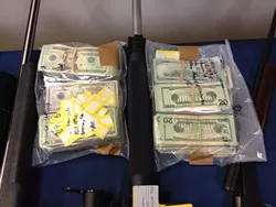 LAWYERS, GUNS, AND MONEY : An early morning raid on eight residences in the Nipomo area netted more than 60 weapons, about $155,000 in cash, and 12 arrests for alleged drug trafficking activity. - PHOTO COURTESY OF SLO COUNTY SHERIFF’S OFFICE