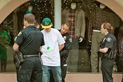 TOO MUCH FUN: A reveler is taken into custody by the San Luis Obispo Police Department on the morning of St. Patrick’s Day after allegedly throwing a water bottle. It was also his 21st birthday. Well-known party holidays like St. Patrick’s Day, Halloween, and Mardi Gras see a heavy police presence in San Luis Obispo, which becomes a “double fine zone” during those times. - FILE PHOTO BY KAORI FUNAHASHI