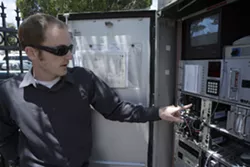 WHERE THE MAGIC HAPPENS : City traffic engineers, like Jake Hudson, used to have to drive out to an intersection utility box to fix traffic signals or the video system. Now, everything happens remotely. - PHOTOS BY STEVE E. MILLER
