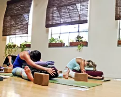 HUSTLE AND FLOW: The participants of Sun and Moon Flow relax after a tough cycle of yoga with blankets and pillows. - PHOTO BY JESSICA PENA