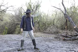 THIS WAS A HOME: Eddie Tolosko surveys the remains of the camp he called home for 11 years. SLO City Park Rangers recently demolished it in the midst of a battle to get him to vacate the area. - PHOTO BY STEVE E. MILLER