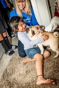 HOPE, STRENGTH, JOY: Little Paige receives her wish of a new dog. Make-A-Wish Foundation of the Tri-Counties grants wishes for children who are battling life-threatening illnesses. Make-A-Wish grants 20 wishes every year in SLO County and is in need of donations from the public. - PHOTO COURTESY OF MAKE-A-WISH FOUNDATION OF THE TRI-COUNTIES