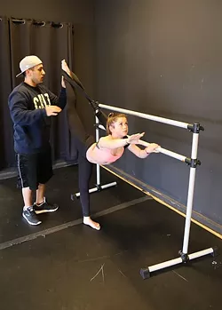 BEHIND THE VIRAL CLIPS: Teen YouTube dance star Sparkles Lund gets stretched out by her choreographer Marco Cruz at her home studio in Arroyo Grande. - PHOTO BY DYLAN HONEA-BAUMANN