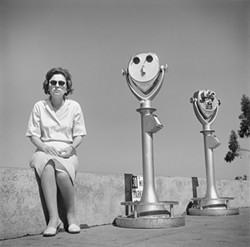 COIN-OPERATED TWIN :  While many street photographers avoided interacting with their subjects, Tress would occasionally direct people to create a desired composition, such as this one. - PHOTO BY ARTHUR TRESS