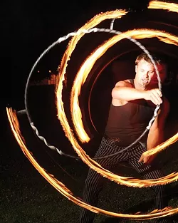 RING OF FIRE : Grant Leonard spins circles during an informal Fluid Luminescence gathering. - PHOTO BY STEVE E. MILLER