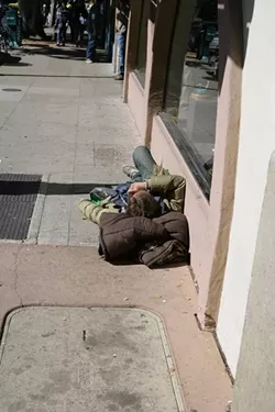 THIS LOOKS LIKE A GOOD PLACE TO SLEEP: OK, technically this could just be a homeless guy, but I couldn’t find any passed-out drunk kids. - PHOTO BY GLEN STARKEY