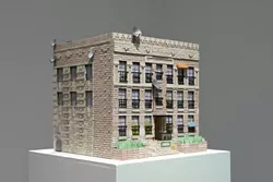 HOUSE BEAUTIFUL : Works like The Rampart, pictured, reveal a striking eye for detail. Satellite dishes, electrical boxes, and tiny bars over the building’s windows imbue the piece with near-photographic realism. - PHOTOS BY STEVE E. MILLER