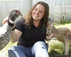 FRIENDS : Zoo to You curator Angela Boelk communes with “Dennis Hopper”, a red kangaroo, and “Stanley Screamer”, an Argentinian crested screamer. - PHOTO BY STEVE E. MILLER