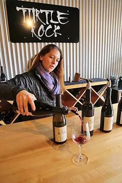 TURTLE ROCK: Claudia Burns of Turtle Rock Wines pours a splash of small-batch Zinfandel at Paso Underground, an eclectic wine hub hidden in downtown Paso Robles. The family-owned winery creates artisanal wines from fruit sourced from the Willow Creek District. - PHOTO BY DYLAN HONEA-BAUMANN