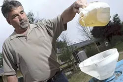 GET WITH THE GREEN PROGRAM : Mike Brown, a board member for the American Biodiesel Buyer’s Club, collects his own fry oil, which will be used to make biodiesel. - PHOTO BY STEVE E. MILLER