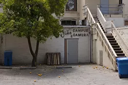 HOLE IN THE WALL: Burglars likely used a skill saw to cut a gaping hole in the back door of Jim’s Campus Camera in downtown SLO, making off with a reported $20,000 worth of merchandise. - PHOTO BY STEVE E. MILLER