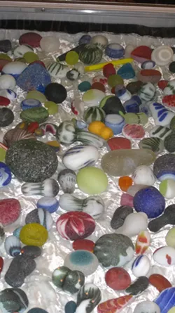 OLD ART, NEAT GLASS: Some of James Lundgren’s finished work sits in the Smithsonian; these botched throwaways were tossed by waves for decades to become the cool collection pictured here.
