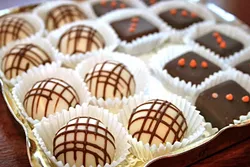 RICH: Truffles of all flavors fill the glass case at Mama Ganache on Monterey Street in SLO. Not only are the chocolates delicious, but they are locally-made, organic, and fair-trade. - PHOTO BY HAYLEY THOMAS