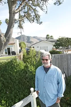 Tim Page wants to reopen a path to the beach that is blocked by a fence and shrubs next to Mark Yandow’s Shell Beach home. - PHOTO BY STEVE E. MILLER