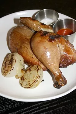 CLUCK IT UP: A whole organic chicken is brined in black tea, salted, and cooked in a wood-fire rotisserie until it is bursting with juices. A half chicken is more than enough to share and comes with house-made hot sauce and buttermilk dip. - PHOTO BY HAYLEY THOMAS
