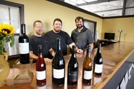 REASON TO SMILE :  Jason Carter (left), the national sales manager and co-owner of Barrel 27 with Mac Myers and Russell From (right) deserves to be merry, considering the raves their value-priced wines have earned. - PHOTO BY STEVE E. MILLER